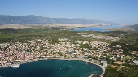 Scenic-Coastal-View-Of-Novalja-Town-On-Pag-Island-In-Croatia---aerial-drone-shot