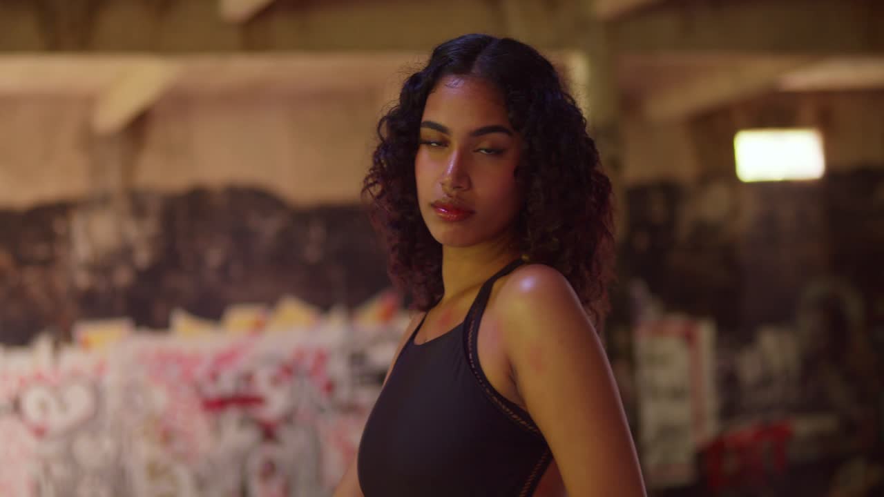 Portrait of a Young Woman with Curly Hair in an Urban Setting