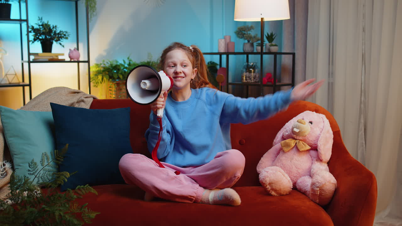 Preteen child girl kid talking with megaphone proclaiming news loudly announcing advertisement