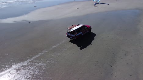 drone view circling around a red lifeguard truck at pacific beach