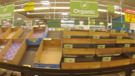 mostly empty produce bins at the grocery store days after devastating winter storm uri