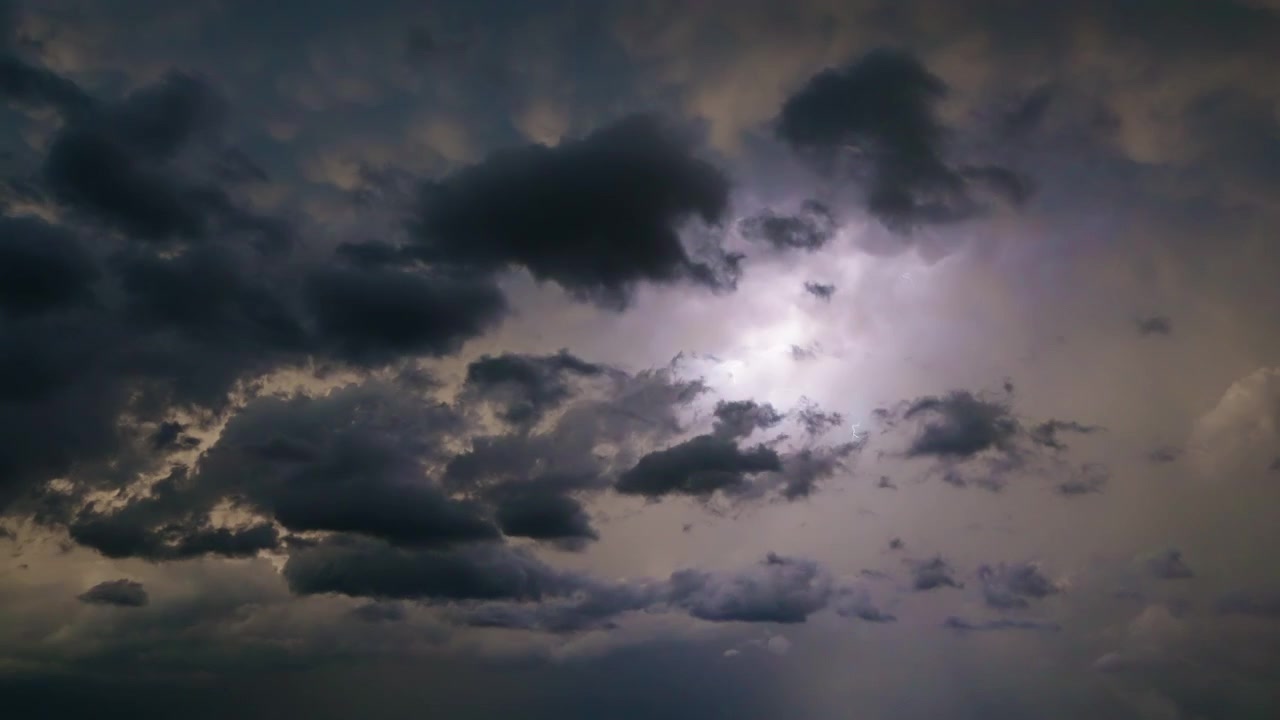 Lightning bolts flashing across beautiful stormy sky in dramatic 4K timelapse