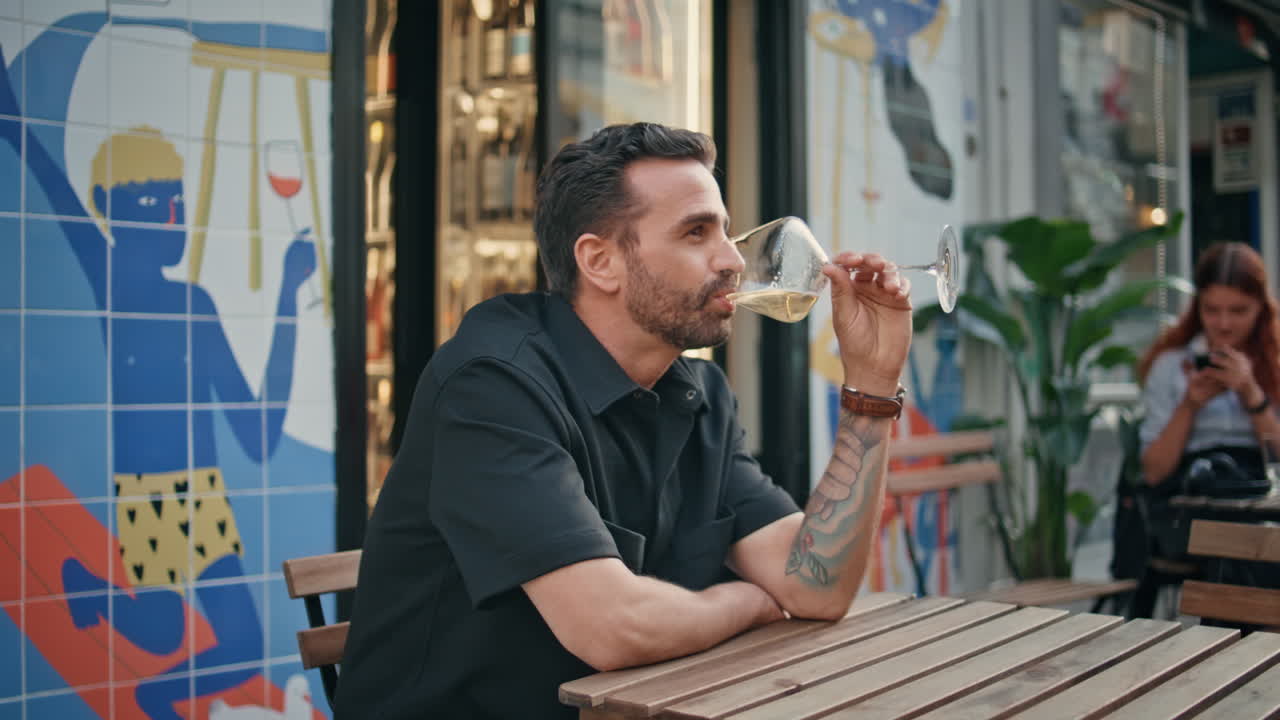 Man sipping wine glass open air cafe bar closeup. Guy drinking alcohol