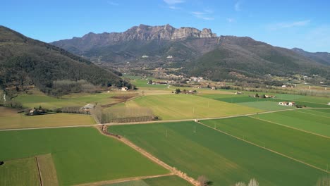 spectacular aerial view of la garrotxa in the province of girona cultivated fields of green color beautiful mountain in the background nature and ecology
