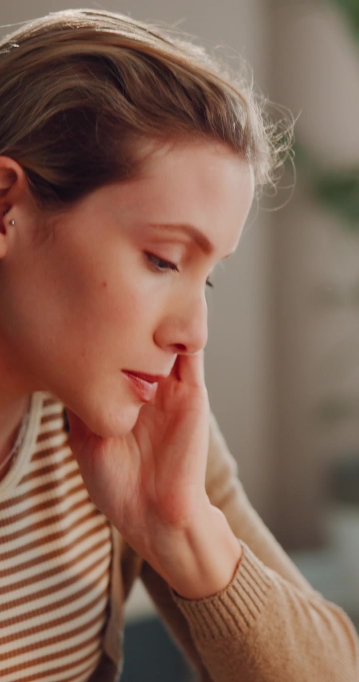 Stressed Young Woman Reading Documents at Home