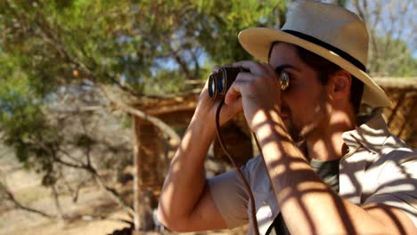 man looking through binocular 4k