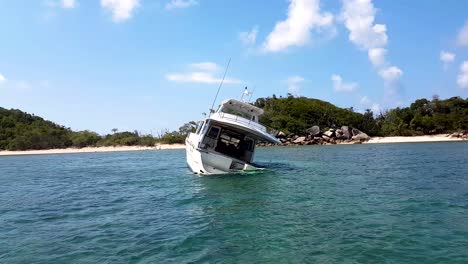 ship wreck crashed in shallow tropical waters with island in background