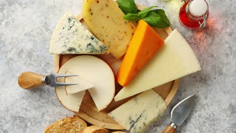 Various-types-of-cheese-served-on-rustic-wooden-board