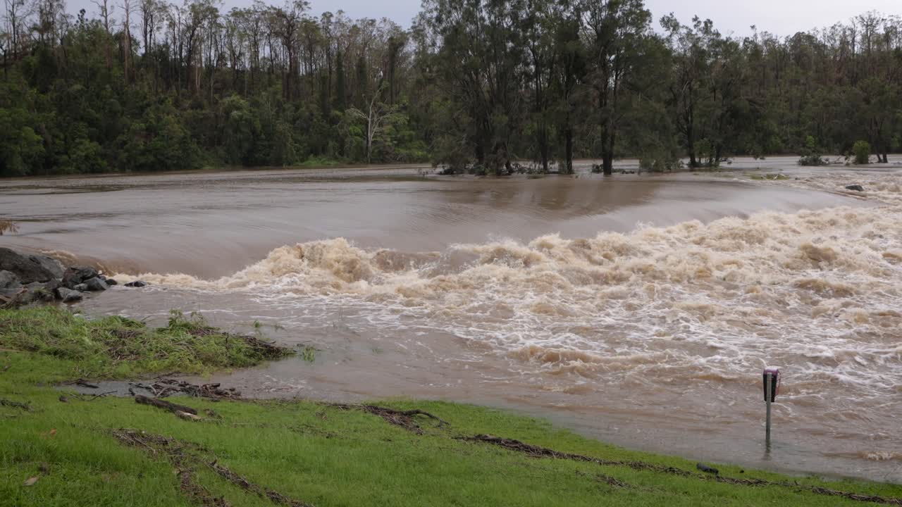 Coomera, Gold Coast, 2 January 2024 - Coomera River Causeway under flood waters from the 2024 Storms in January