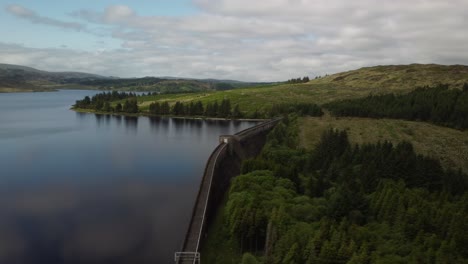 Wide-angle-orbital-aerial-footage-of-reservoir-dam-in-the-countryside