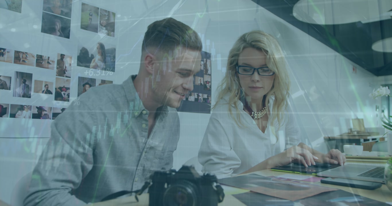Animation of graphs, numbers over caucasian man and woman checking printed photograph at office