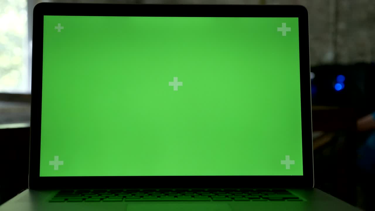 Close shot of laptop's display with chromakey in modern office
