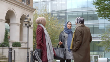 group of british muslim businesswomen outside office