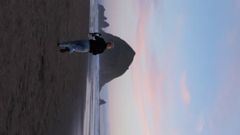 Woman-Running-on-Cannon-Beach,-Oregon-at-Sunset---Freedom,-Wanderlust-Concept