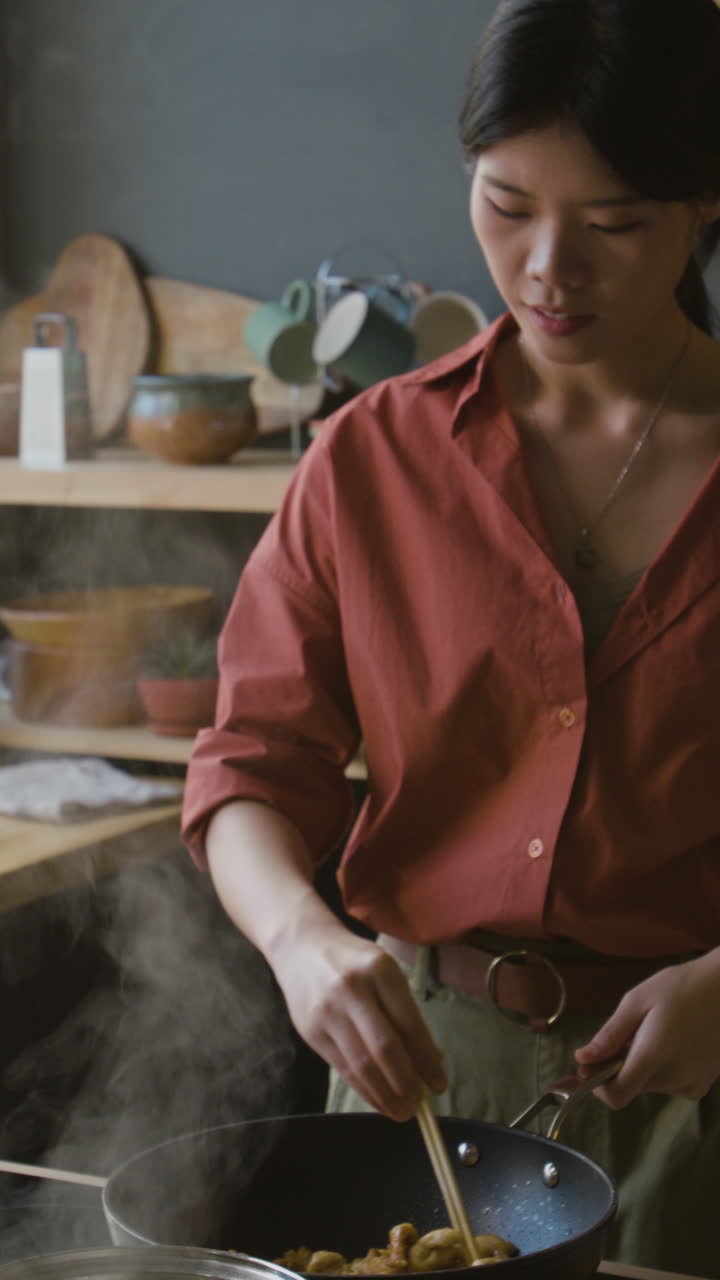 Woman Cooking Stir-fry in a Kitchen