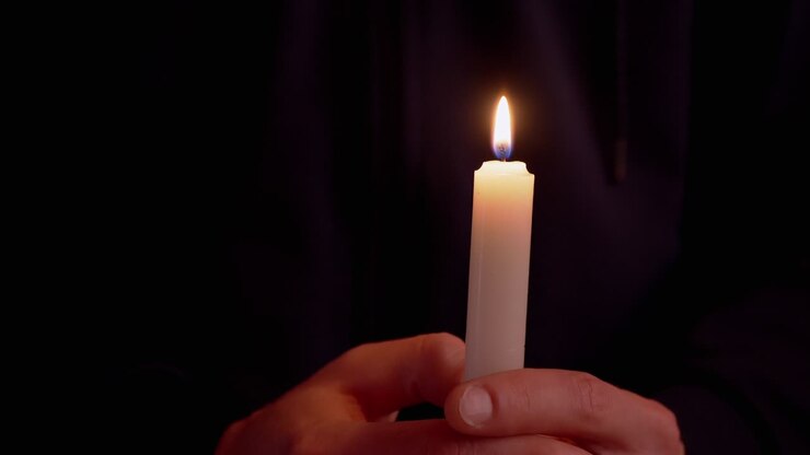 Male Holds a Candle in Hands, the Woman Arms Sets it on Fire in a Dark Room. 4