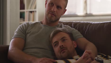 Caucasian-male-couple-in-social-distancing-in-their-sofa-at-home