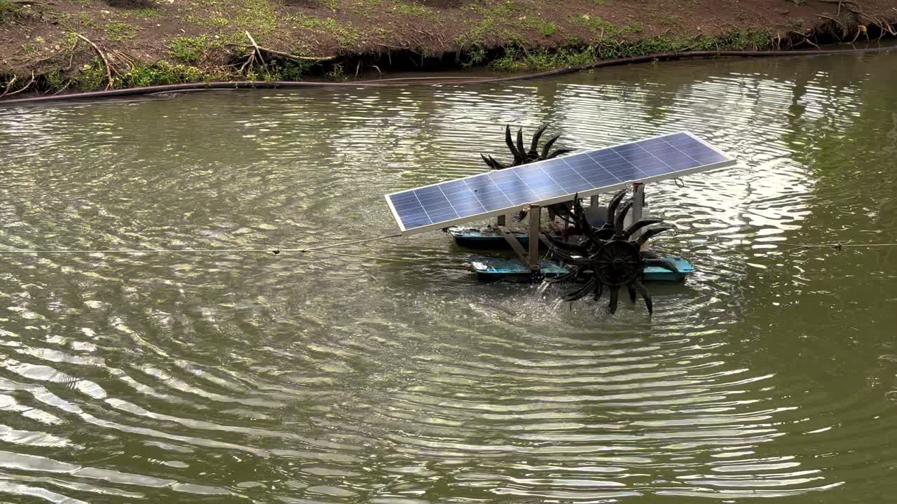 A solar cell system of paddle wheel aerators running in real-time. Space for text and landscape footage of a Solar cell paddle wheel aerator in a small canal.