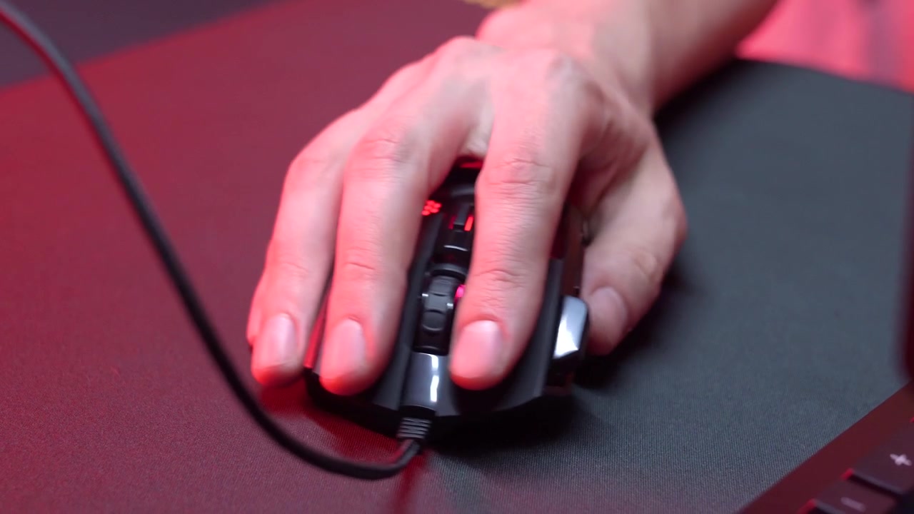 Close-up of Hand Operating a Gaming Mouse with RGB Lighting