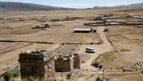 explore the ancient chullpas de molloco archaeological site in peru with this tilt shot. unique stone tombs set within a vast, dry landscape under a clear sky