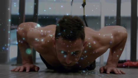 animación de manchas brillantes sobre un hombre musculoso y fuerte haciendo flexiones