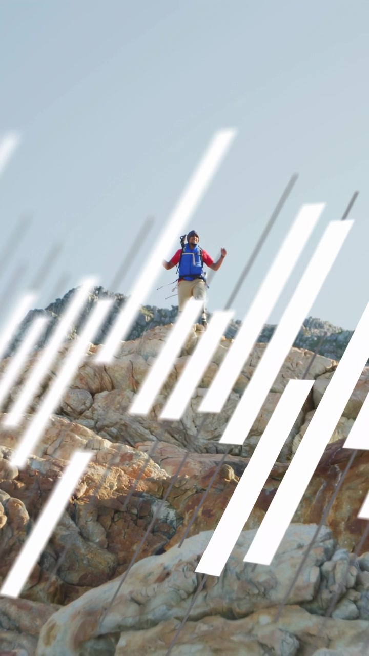 Vertical video: Travel hiker stepping rocky ridge, white bars sweeping over frame, reaching summit