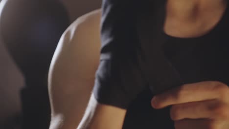 man wrapping hand with black bandage for boxing training