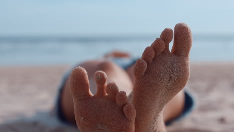 Cerrar-Los-Pies-De-Una-Mujer-Relajándose-En-La-Playa-Turista-Disfrutando-De-Unas-Cálidas-Vacaciones-De-Verano-En-La-Playa-Tropical