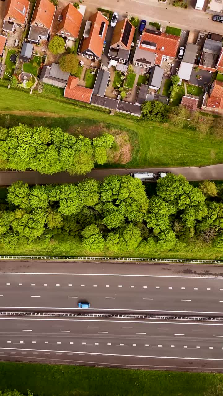 Aerial View of a Dutch Residential Area with Highway and Green Spaces