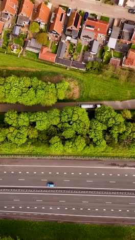 aerial view of a dutch residential area with highway and green spaces
