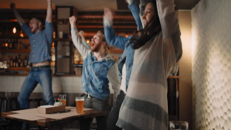 a group of men and women in a pub together cheer for their national team at the world cup in football basketball hockey. celebrate the goal scored the puck. celebrate the victory