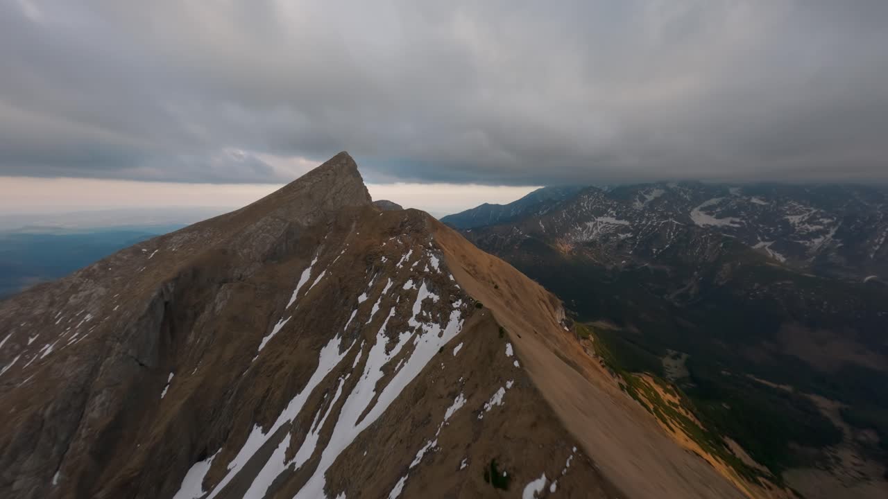 Rocky ridgeline and lush treeline of the Tatras from FPV mountain flight