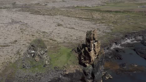 londrangar basalt towers on shore of snæfellsnes peninsula in iceland