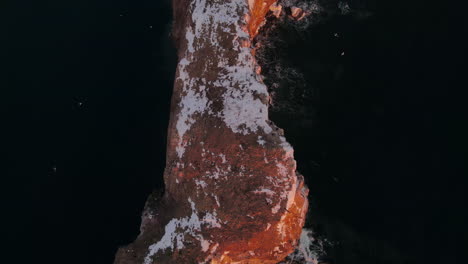 Drine-top-down-view-at-60fps-of-famous-Perce-rock-in-Percé,-Québec,-Canada