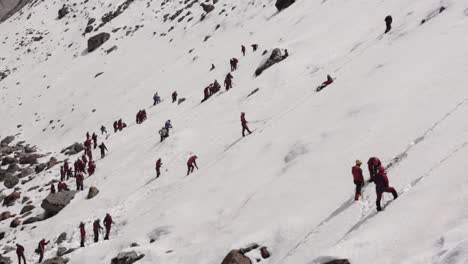 a view of snowy mountain of himalayas, uttarakhand india and mountaineers climbing the snowy mountains in large number