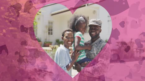 Animation-of-hearts-over-happy-african-american-family-in-garden