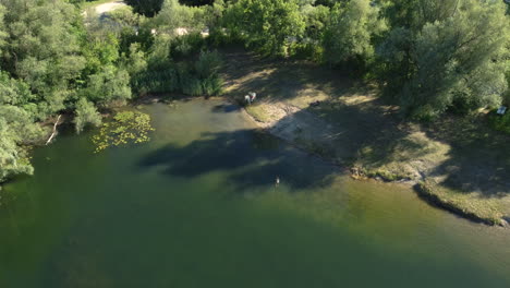 aerial view of a lake with people swimming