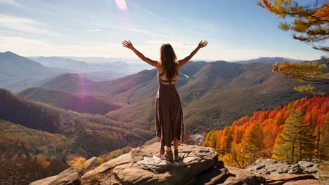 person enjoying scenic mountain view with arms raised in fall