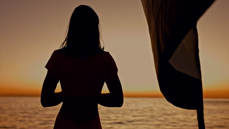 silhouette, sea and woman on cruise ship at sunset