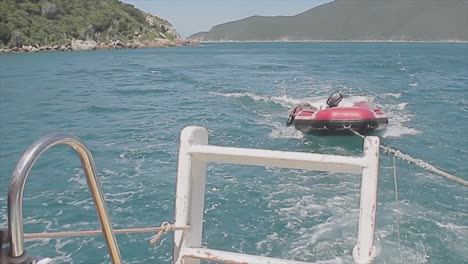 rescue boat on a beach being pushed by a bigger boat