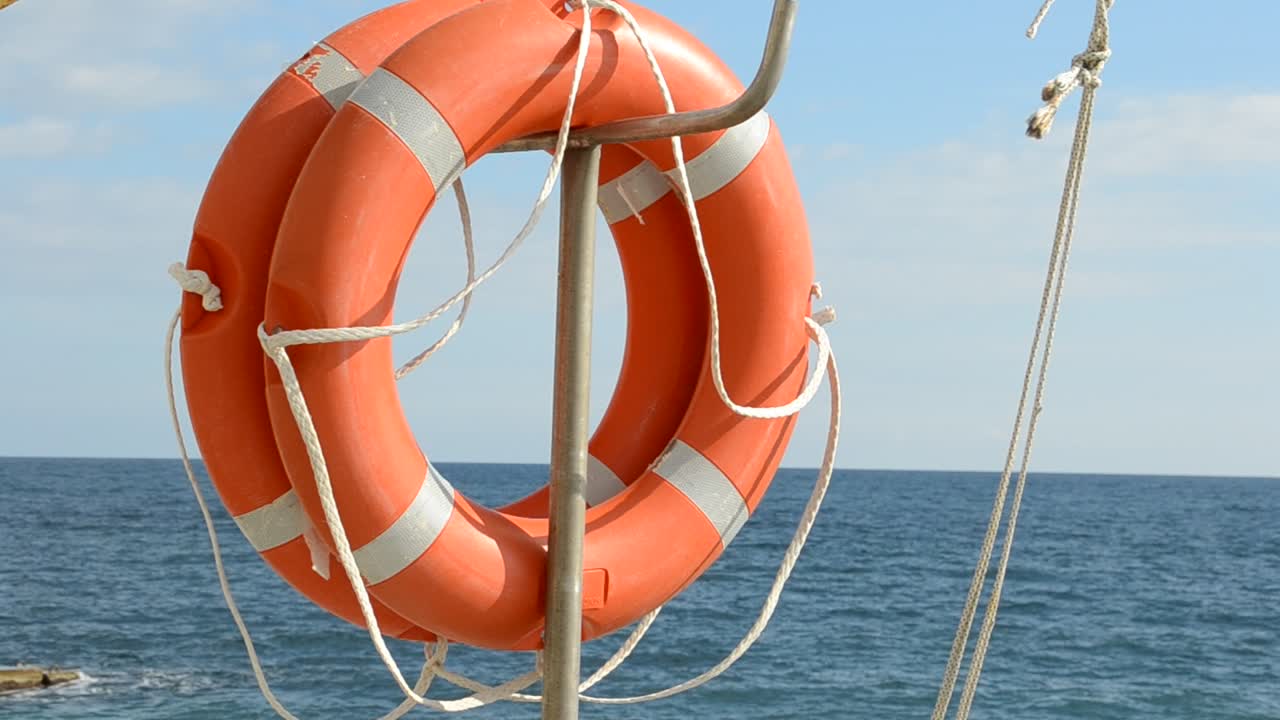 Life ring floating on top of sunny blue water