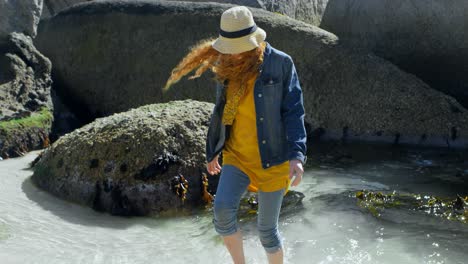 Woman-walking-on-a-water-at-beach-4k