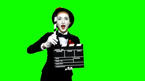 mime holding clapperboard on green screen