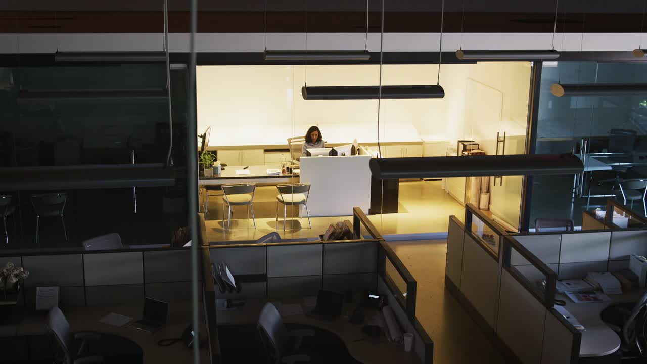 Young businesswoman working in empty office, elevated view
