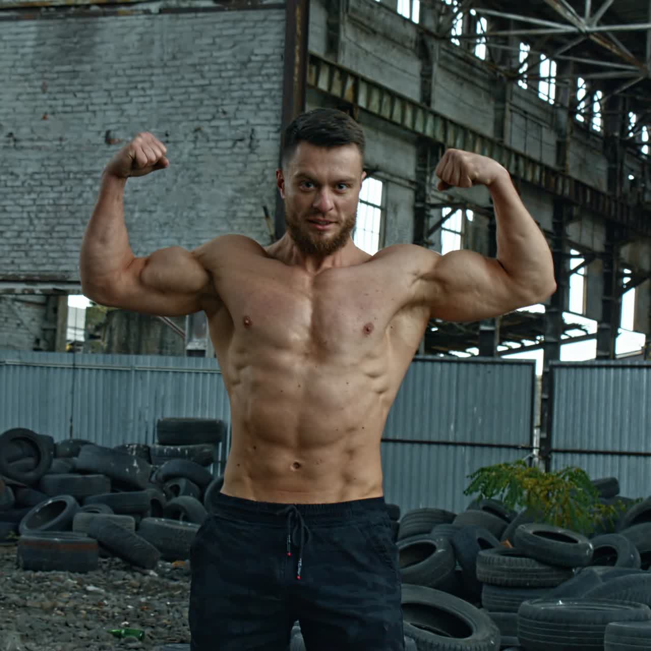 Shirtless bodybuilder posing outdoor