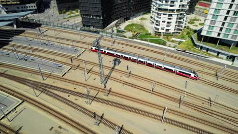 Austria-Vienna-railway,-train-arriving-at-train-station,-aerial-drone-view