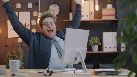 happy employee celebrating success in the office