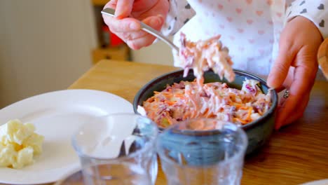 Woman-serving-meal-in-kitchen-at-home-4k