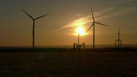 wind turbines at sunrise with golden sky i oregon, united states. - wide static