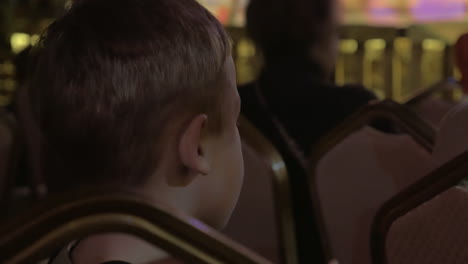 boy watching theatrical performance and applauding